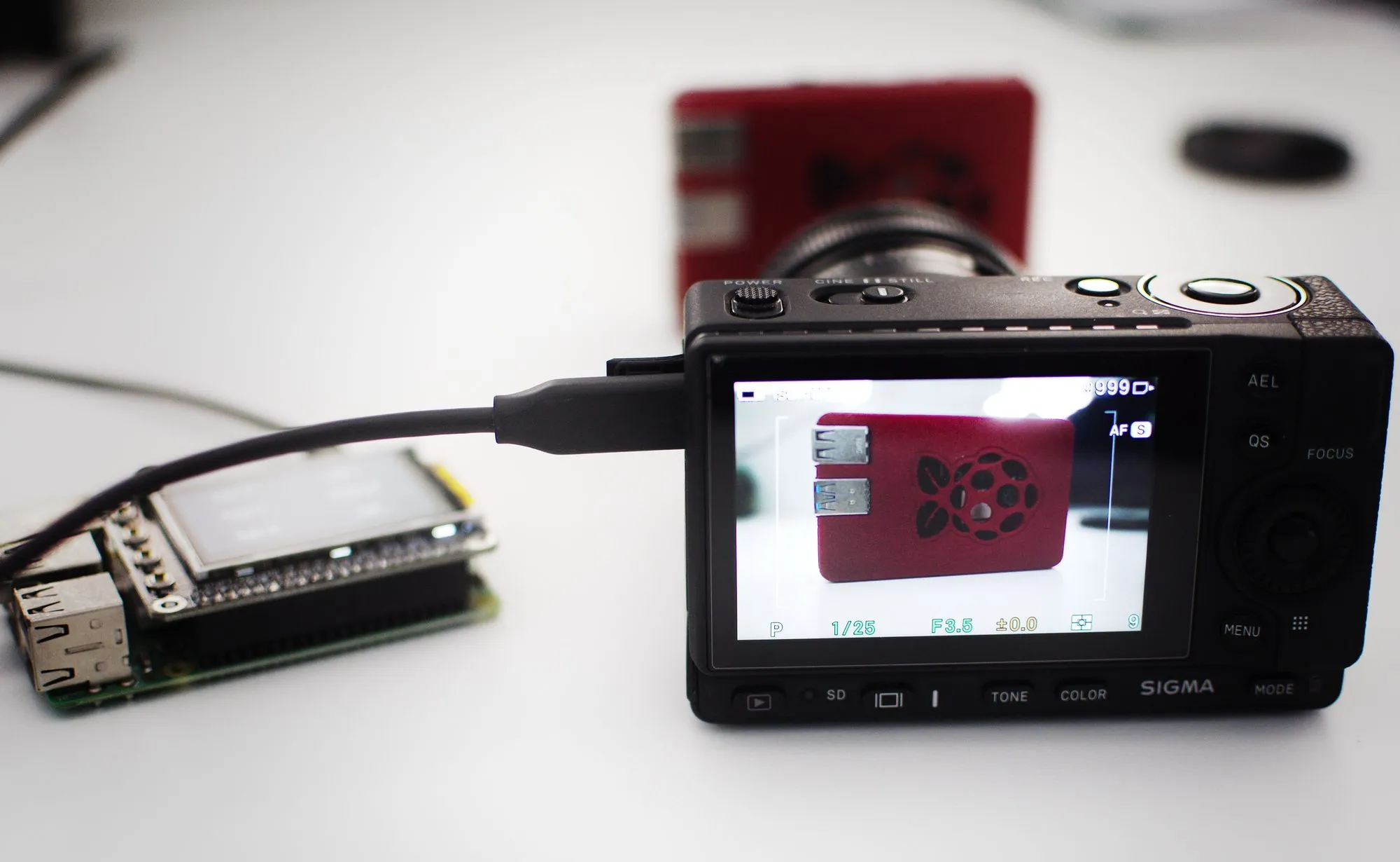 La Sigma fp conectada por USB a la Raspberry Pi, con la imagen en vivo en su pantalla trasera